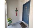 Condo entrance with a blue door, door mat, and a plant on a stand to welcome guests at 4304 Clubside Dr # 4304, Longwood, FL 32779