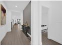 Bright hallway featuring modern decor and beautiful tile flooring throughout the home at 4472 Lions Gate Ave, Clermont, FL 34711
