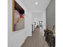 Bright hallway featuring modern decor and beautiful tile flooring throughout the home at 4472 Lions Gate Ave, Clermont, FL 34711