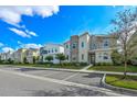 Exterior view of modern townhomes featuring landscaping, sidewalks and parking at 4532 Target Blvd, Kissimmee, FL 34746