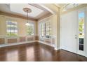 The dining room has a large window and a light-colored wall that contrasts with the dark hardwood flooring at 4770 Cains Wren Trl, Sanford, FL 32771