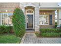 The attractive front door is framed by stone and brick, set back from the street with a brick walkway at 4770 Cains Wren Trl, Sanford, FL 32771