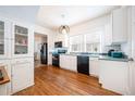 Spacious kitchen featuring white cabinetry, hardwood floors and modern appliances at 520 E Anderson St, Orlando, FL 32801