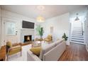 Bright living room featuring a cozy fireplace, hardwood floors and neutral decor at 520 E Anderson St, Orlando, FL 32801