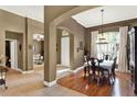 Elegant dining room with hardwood floors, arched doorway, and plenty of natural light at 873 Gulf Land Dr, Apopka, FL 32712