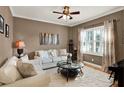 Comfortable living room featuring a large window, plush seating, and stylish decor at 873 Gulf Land Dr, Apopka, FL 32712