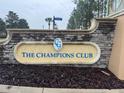 Elegant stone signage at The Champions Club community entrance creates a great first impression for residents and visitors at 8950 Azalea Sands Ln # 8950, Champions Gate, FL 33896