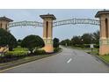 Inviting entrance to Champions Gate with lush landscaping and well-maintained roadway for an upscale community feel at 8950 Azalea Sands Ln # 8950, Champions Gate, FL 33896
