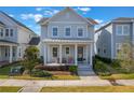Charming two-story home with a welcoming front porch and well-manicured landscaping at 896 Tilden Oaks Trl, Winter Garden, FL 34787