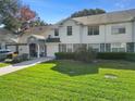 Charming townhome with manicured lawn, stone accents, and a welcoming entrance at 923 Lexington Pkwy # 14, Apopka, FL 32712