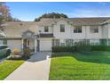 Inviting townhouse with attached garage, well-maintained lawn, and classic facade at 923 Lexington Pkwy # 14, Apopka, FL 32712