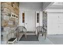 Close-up of the front porch, with stone accents, seating, and front door at 923 Lexington Pkwy # 14, Apopka, FL 32712