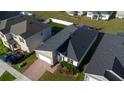 Aerial view of a single Gathering home featuring a paved driveway, attached garage, and well-maintained front lawn at 1114 Turquoise Waves Cv, Kissimmee, FL 34747