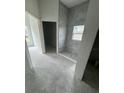 Bathroom featuring a tiled shower enclosure, a window and concrete flooring at 13441 Sw 60Th Avenue Rd, Ocala, FL 34473