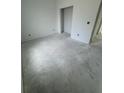Unfinished bedroom featuring light walls, concrete flooring, and an open doorway at 13441 Sw 60Th Avenue Rd, Ocala, FL 34473