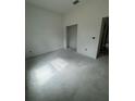 Unfinished bedroom with an open doorway showing neutral-colored walls and a bare concrete floor at 13449 Sw 60Th Avenue Rd, Ocala, FL 34473