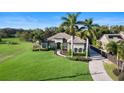 An aerial shot captures the property's expansive lawn, mature trees, and convenient circular driveway at 1384 E Lake Shore Blvd, Kissimmee, FL 34744