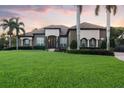 Charming home boasts a tile roof, lush lawn, and manicured bushes, offering delightful curb appeal at 1384 E Lake Shore Blvd, Kissimmee, FL 34744