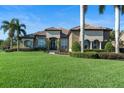 Attractive single story home featuring stucco facade, tile roof and manicured landscaping at 1384 E Lake Shore Blvd, Kissimmee, FL 34744