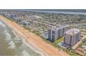 A stunning aerial view of a high-rise community along the sandy beach at 1415 Ocean Shore Blvd # 704, Ormond Beach, FL 32176