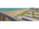 Balcony view overlooking a scenic beach and coastal neighborhood at 1415 Ocean Shore Blvd # 704, Ormond Beach, FL 32176