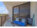 Balcony with seating area and sliding glass doors, offering outdoor living space at 1415 Ocean Shore Blvd # 704, Ormond Beach, FL 32176