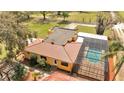 Spacious property featuring mature landscaping, a pool with screened enclosure, and tile roof at 1775 Druliner Rd, St Cloud, FL 34771