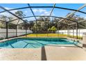 Sparkling pool in screened enclosure offers outdoor enjoyment and privacy at 2564 Bullion Loop, Sanford, FL 32771