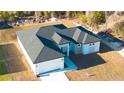 New home with a modern roof design, two-car garage, and landscaped front yard at 2629 Sw 163Rd Pl, Ocala, FL 34473