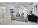 Bright living room boasts high ceilings, stylish furnishings, and ample natural light from the French doors at 4178 S Chickasaw Trl, Orlando, FL 32829