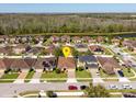 Aerial view of homes in a community with backyard lake views, mature trees and manicured lawns at 4605 Kalispell Rd, Kissimmee, FL 34758