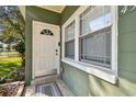 Close up of the front door, showing a white door with glass details and a secure lock at 4900 Kempston Dr, Orlando, FL 32812