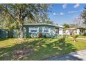 Charming single-story home with mature trees, a well-maintained lawn, and inviting curb appeal at 4900 Kempston Dr, Orlando, FL 32812