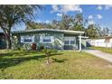 Well-maintained single-story home featuring a lush lawn and inviting curb appeal at 4900 Kempston Dr, Orlando, FL 32812