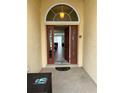 Welcoming entryway with a red door and views into the home's open-concept living spaces at 5356 Oakbourne Ave, Davenport, FL 33837