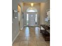 Inviting foyer with tiled floors and an arched doorway leading to other areas of the home at 5356 Oakbourne Ave, Davenport, FL 33837