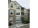 Three-story condo building with large windows, screened balconies, and accessible ramp surrounded by lush landscaping at 586 Brantley Terrace Way # 201, Altamonte Springs, FL 32714