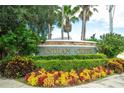 Indian Creek community entrance sign surrounded by lush, colorful landscaping at 8095 Indian Creek Blvd, Kissimmee, FL 34747