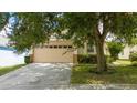 Charming single Gathering home featuring an attached two-car garage, with an ample driveway at 8095 Indian Creek Blvd, Kissimmee, FL 34747