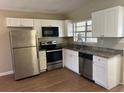 Well-equipped kitchen with stainless steel appliances and sleek white cabinetry at 905 Governors Ave, Orlando, FL 32808