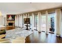 Bright living room featuring a stone fireplace and large windows with sheer curtains at 976 E Michigan St # A, Orlando, FL 32806