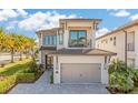 Lovely two-story home boasting a balcony, front lawn, and two-car garage at 985 Jack Nicklaus Ct, Kissimmee, FL 34747