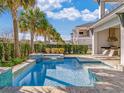 Stunning private backyard pool and spa area with built-in grill and outdoor seating at 985 Jack Nicklaus Ct, Kissimmee, FL 34747