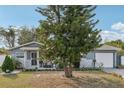 Charming single-story home with a cozy front porch, garage, and mature landscaping at 1004 Sunwood Lane Ln, Orlando, FL 32807