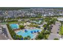 Aerial view showcasing the community pool, surrounding houses, and green spaces at 10052 Peebles St, Orlando, FL 32827