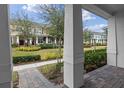 Inviting front porch view of townhomes with landscaped lawns and brick walkways at 10358 Spring Arbor Ln, Winter Garden, FL 34787