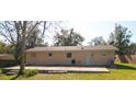 View of single-story home featuring a covered back patio and a spacious grassy yard at 1041 Vihlen Rd, Sanford, FL 32771