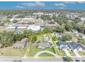 Expansive aerial view of property showing lush grounds with mature trees and nearby community features with yellow boundary lines at 111 Clark St, Oviedo, FL 32765