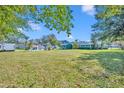 Vast backyard with ample green space offers endless possibilities for outdoor activities and recreation with storage building at 111 Clark St, Oviedo, FL 32765