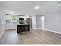 Bright and spacious kitchen featuring white cabinets, stainless steel appliances, and a stylish kitchen island at 1125 E Hubbard Ave, Deland, FL 32724